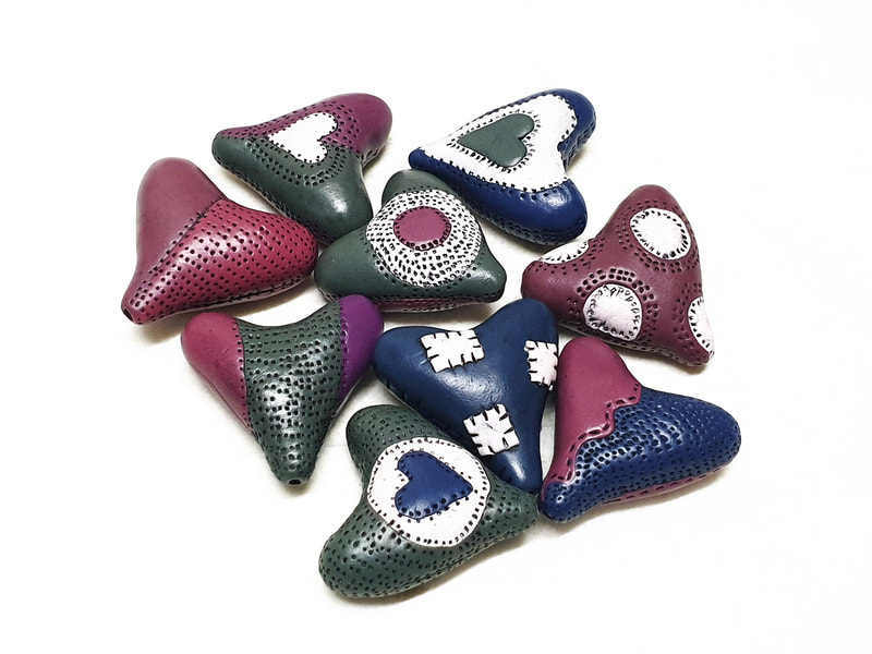 Hollow heart shaped polymer clay beads.