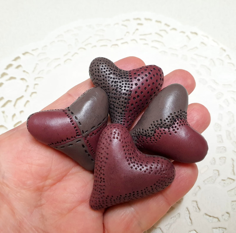 Hollow heart shaped polymer clay beads.